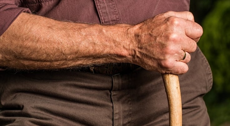 closeup of an old man holding a cane