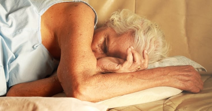 elderly woman sleeping on her side
