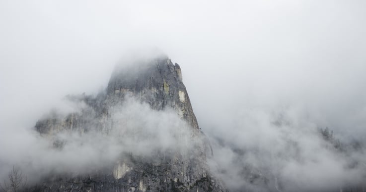 mountain peak shrouded in fog